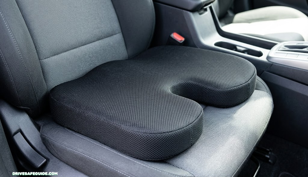 Close-up of an orthopedic memory foam cushion with a coccyx cutout on a car seat