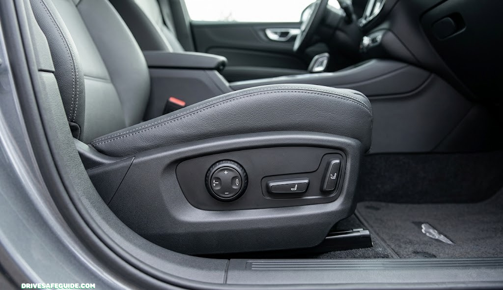 Close-up of car seat lumbar adjustment dial and driver seat controls